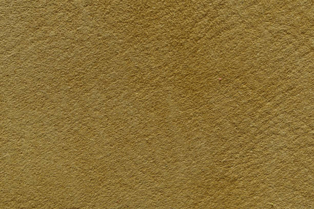 istock Mustard yellow wall with a subtle texture, a warm and inviting background perfect for design projects. 2102585416
