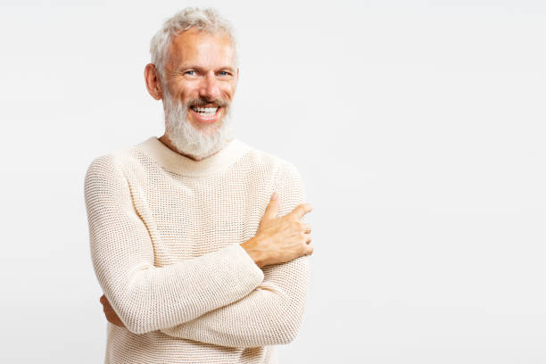 istock Smiling bearded man wearing stylish warm sweater hugging himself, looking at camera 2102598106
