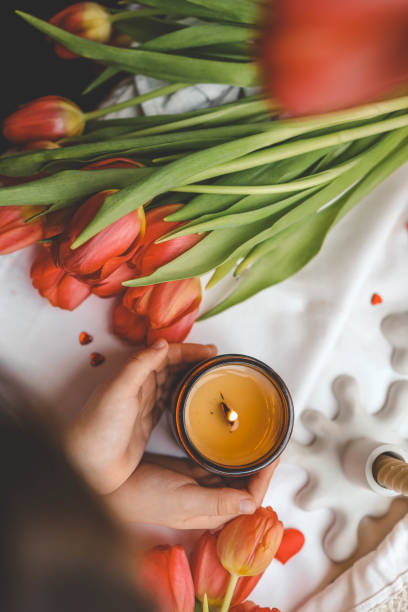 istock A girl holds a candle in her hands, spring mood 2102604619