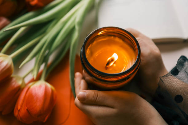 istock Candle and bouquet of red tulips, spring aesthetics 2102606187