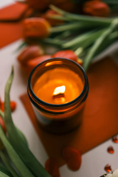 istock Candle and bouquet of red tulips, spring aesthetics 2102606191
