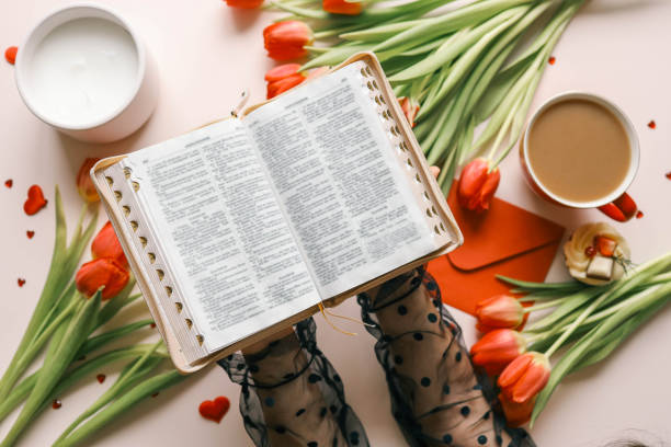 istock Open bible close-up in hands 2102609353
