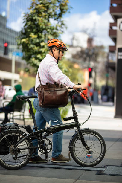 istock Mature Asian Cyclist with his Bicycle in Downtown LA - Vertical 2102628704
