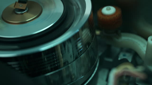 Inside of the Video Cassette Player - Tape Transport Mechanism Wraps the Tape around the Head Drum - Macro, Dark Mood