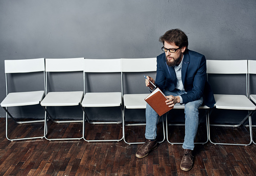 Man sitting on a chair one waiting job interview job. High quality photo