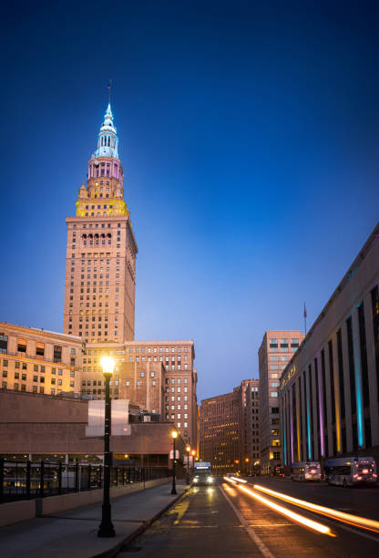 This is a long exposure of the Terminal Tower at twilight with cars driving by in downtown Cleveland, Ohio.