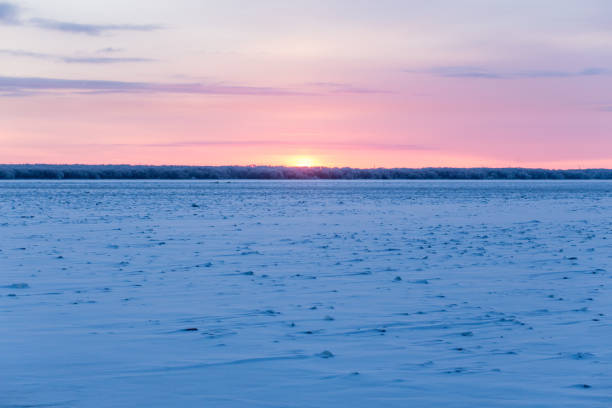 istock The sun dips below the horizon, casting a golden glow over the tranquil water 2102708154