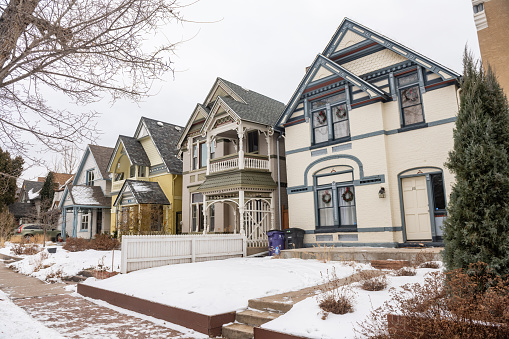 This is a photograph of colorful Western style houses in the historic Baker neighborhood in Denver, Colorado on a winter day.