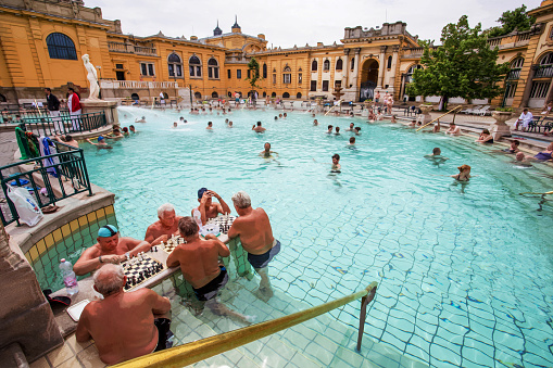 04-26-2014   Budapest Hu Old  Szechenyi baths (1909) in Budapest: people enjoy a treatment and play chess in water - funny!