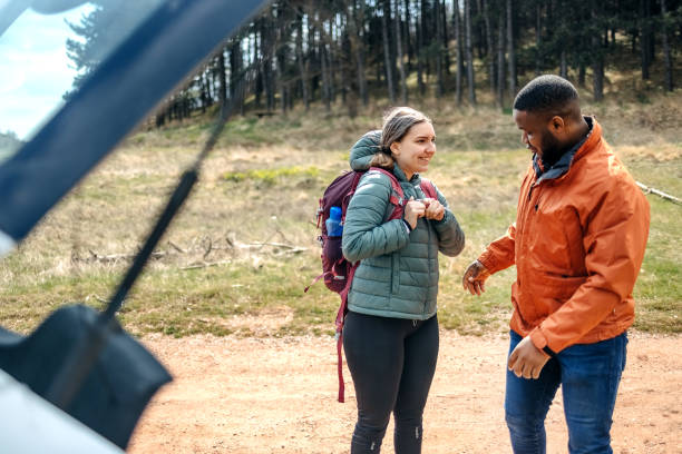 istock Young couple preparing for hiking in nature 2102729968
