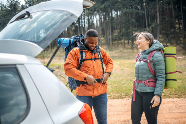 istock Young couple preparing for hiking in nature 2102729976