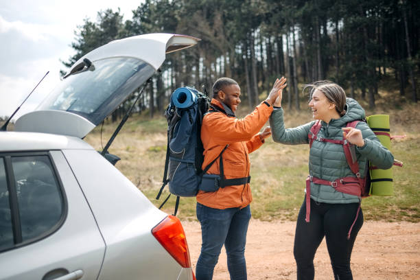 istock Young couple preparing for hiking in nature 2102729977