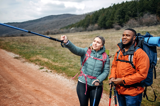 Two people living healthy lifestyle with hiking in nature