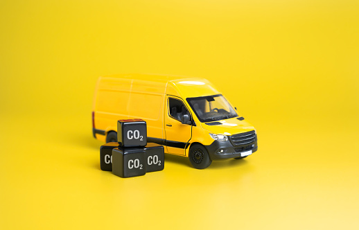 Delivery van and cubic CO2 gas. The carbon footprint of logistics industry. Global carbon emissions. Fossil fuels. Optimizing delivery routes, electrification of rolling stock