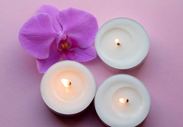 Beautiful orchid flower and lit candles.