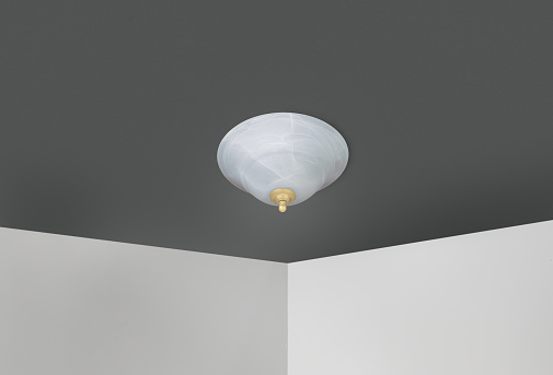 Ceiling mounted light fixture with white walls and black ceiling