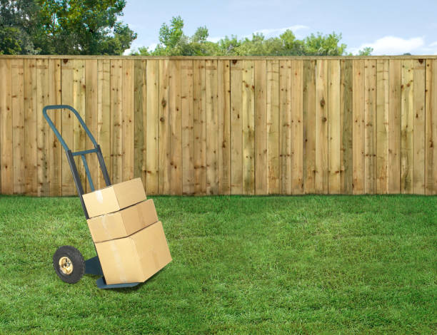 istock Arriving order on a hand truck with boxes on it in a backyard 2102806236