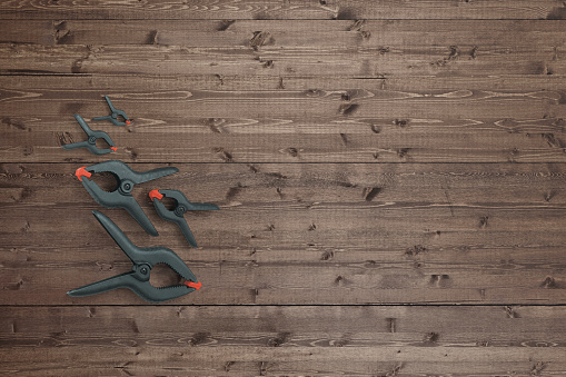 Plastic spring clamps on a wood background