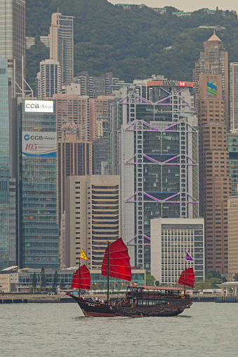 Hong Kong, China - April 27, 2017: Traditional Junk Boat Cruising at Victoria Harbour Spring Day.