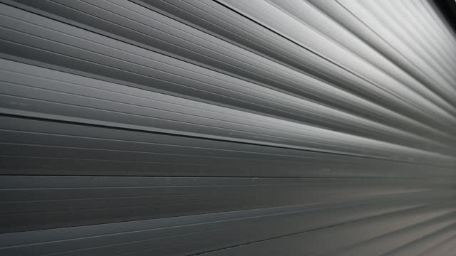 A close-up video of a gray metal wall