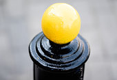 Metal barrier post, separating a road from the sidewalk