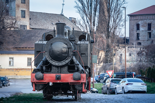 Picture of a serbian steam locomotive standing in a courtyard of an abandoned train station in Pancevo, Serbia.