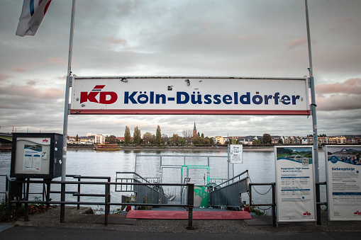 Bonn, Germany - November 7, 2022: Picture of a sign with the logo of KD Koln Dusseldorfer taken in Bonn. Köln-Düsseldorfer is a river cruise operator based in Cologne, Germany. The company operates a total of 14 cruise ships on the Rhine, Main and Moselle rivers. The famous KD steamer line operated on the Rhine with steamers and tourist boats. The Lorelei rock was a famed day outing for pleasure seekers.