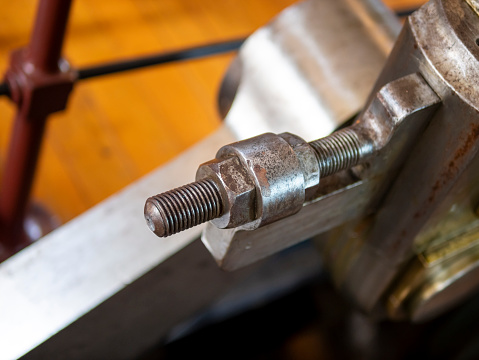 Middle-aged man using a wrench will check the quality of fastening the boiler parts to the metal flange. Qualified repair of a water heater. Service and repair of household appliances.