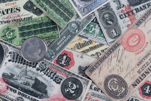 istock Old west period US banknotes and silver certificates with silver dollar coins 2102879030