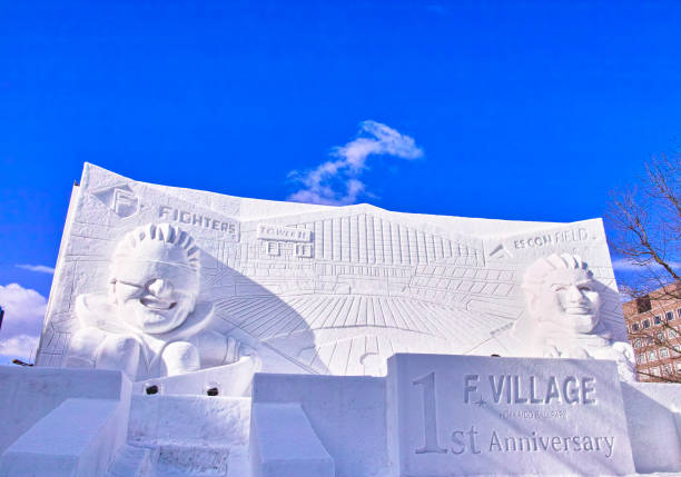 Sapporo, Hokkaido, Japan - February 9, 2024: Sapporo Snow Festival with blue sky and snow statues of anime characters.