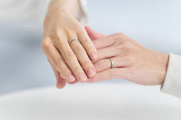 istock Couple holding hands and showing wedding rings 2102930053