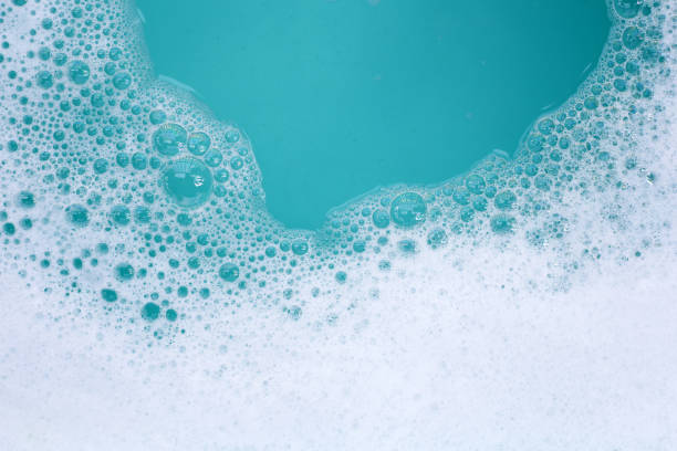 istock Detergent foam bubble on water. Blue background, Soap sud 2102949857