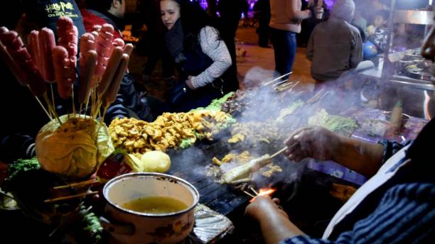 Lima, Peru - September 7, 2019 : Evening scene of a lively street food vendor grilling various meats for customers, city of Canta located north of Lima - Peru