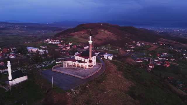 AERIAL Drone Shot of Mosque with Minaret in Small Town of Bihać Under Sky During Blue Hour