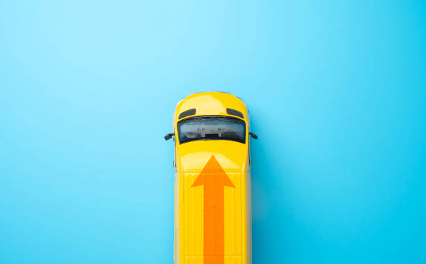 istock Yellow delivery car with an arrow. E-commerce, retail, or distribution networks. Efficiency, speed, and reliability in transportation and logistics. Delivering goods and services. 2102991288
