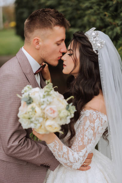 istock Wedding. Love and couple in garden for wedding. Celebration of ceremony and commitment. Save the date. Trust. The bride and groom embrace. Smile and love. Photo of happy and in love brides and grooms. 2102997122