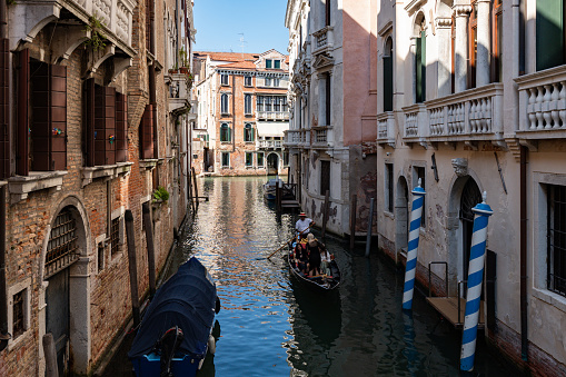 Venice, Italy - August 18 2023: Scenic canal with ancient buildings in Venice, Italy on a sunny summer day