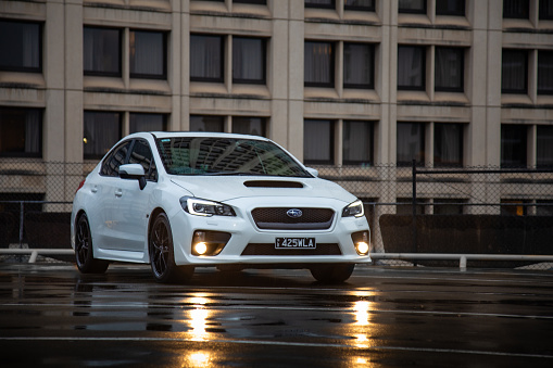 Sporty Subaru WRX sedan clicked during a creative photoshoot showing front three-quarters view with fog lamps turned on for added visibility.