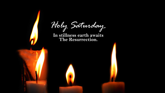 Holy Saturday. In stillness earth awaits The Resurrection. With candle lights on dark or black background. Happy Holy week card with quotes and light of candles. Religious Christianity concept.