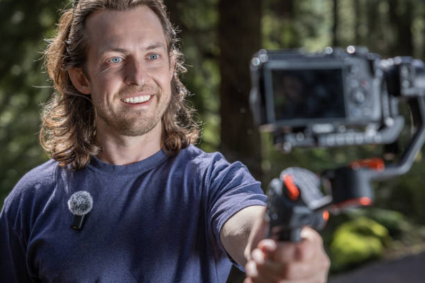 istock Young man filming with a camera gimbal 2103087640