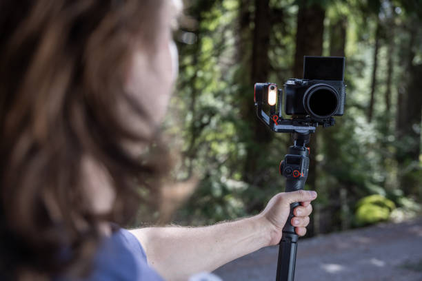 istock Young man filming with a camera gimbal 2103092379