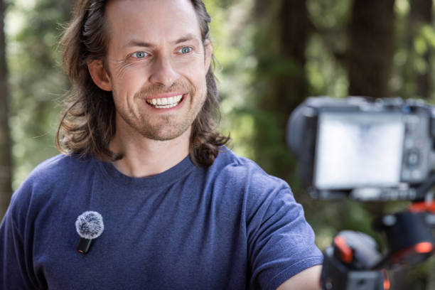 istock Young man filming with a camera gimbal 2103095981
