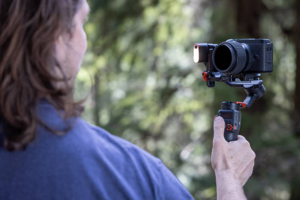 istock Young man filming with a camera gimbal 2103097065
