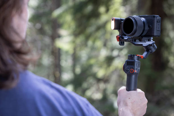 istock Young man filming with a camera gimbal 2103097577