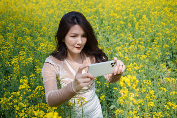 istock Woman taking photo with mobile phone 2103098100