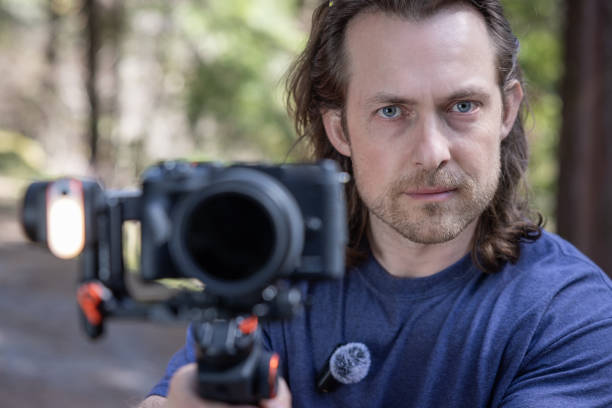 istock Young man filming with a camera gimbal 2103098612