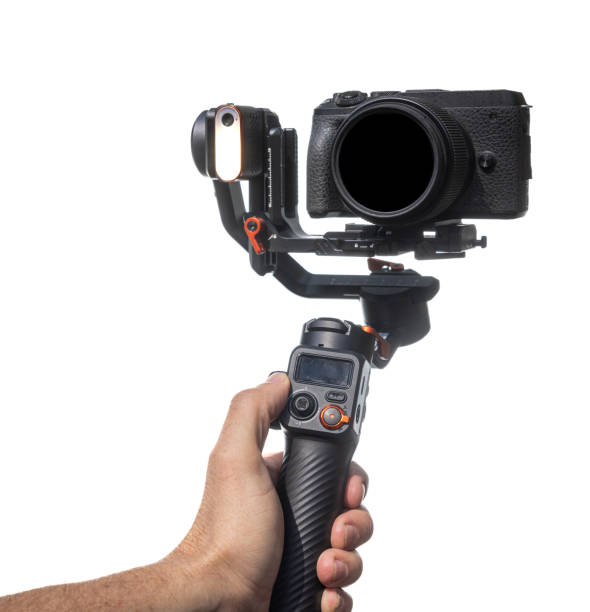 istock A person is holding a camera gimbal on a white background. 2103100226