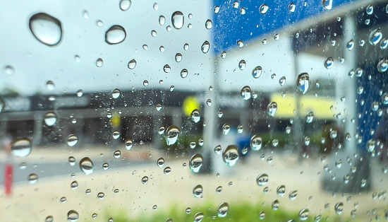 Rain droplets on glass car window. rain weather.