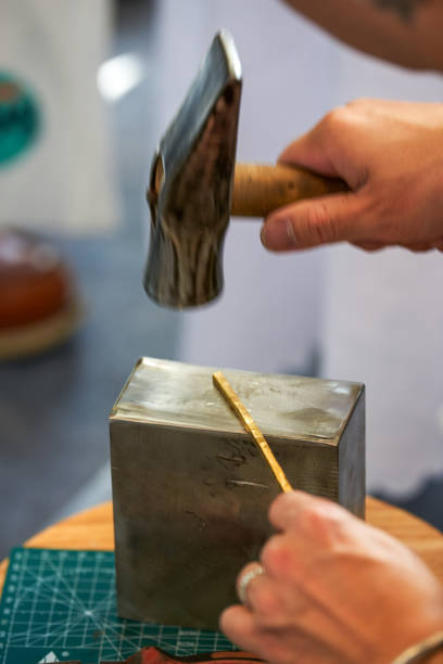 istock A traditional craftsman creates metal jewelry pieces 2103122942