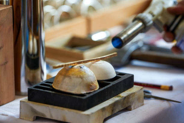 A traditional craftsman creates metal jewelry pieces